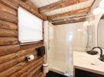 Main level bathroom has a new shower for 2023 and plenty of storage space